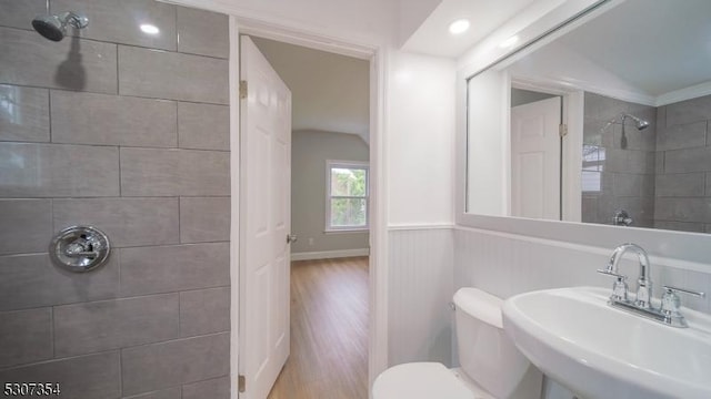 16 New St, Montclair Twp, NJ 07042 - bathroom featuring tiled shower, lofted ceiling, wood finished floors, and wainscoting