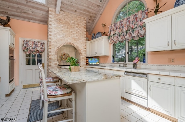 kitchen featuring sink, dishwasher, light tile patterned flooring, and wooden ceiling