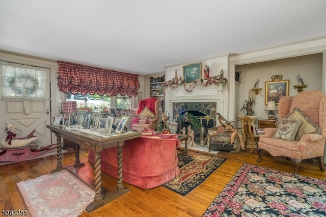 living room with hardwood / wood-style floors and a fireplace