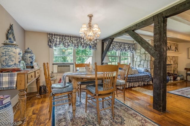 dining area featuring a notable chandelier, cooling unit, and dark hardwood / wood-style flooring