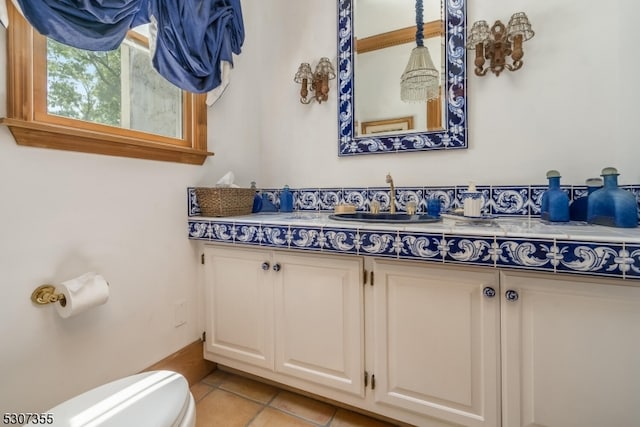 bathroom with vanity, toilet, and tile patterned floors