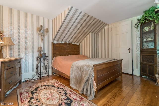 bedroom with hardwood / wood-style flooring and vaulted ceiling