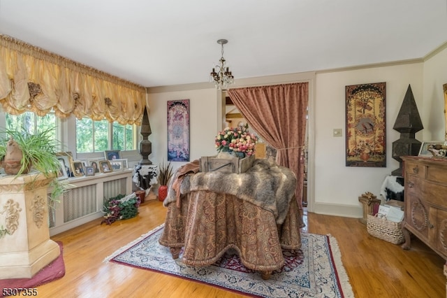 dining space with hardwood / wood-style floors and a notable chandelier