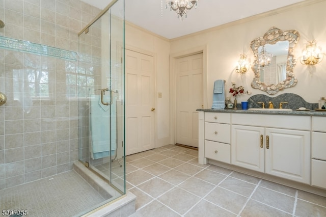 bathroom with an inviting chandelier, walk in shower, vanity, crown molding, and tile patterned floors