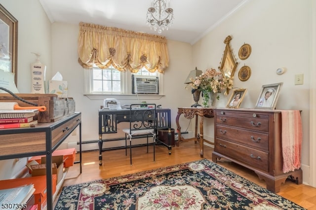 living area featuring crown molding, a notable chandelier, and hardwood / wood-style floors