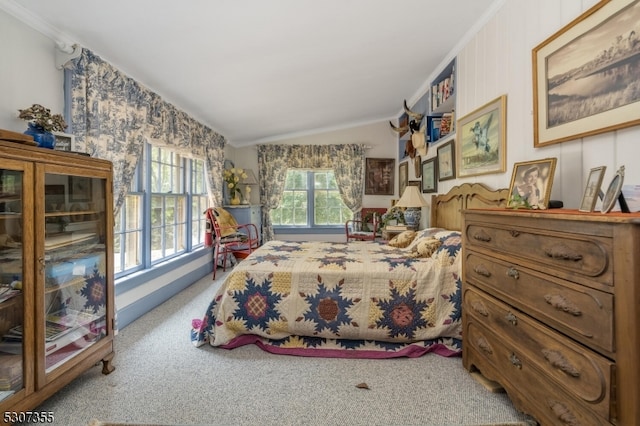 carpeted bedroom featuring lofted ceiling and crown molding