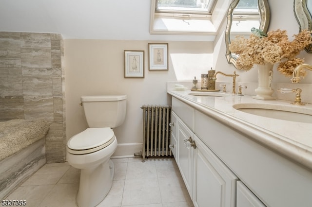 bathroom featuring a skylight, radiator heating unit, toilet, vanity, and tile patterned flooring