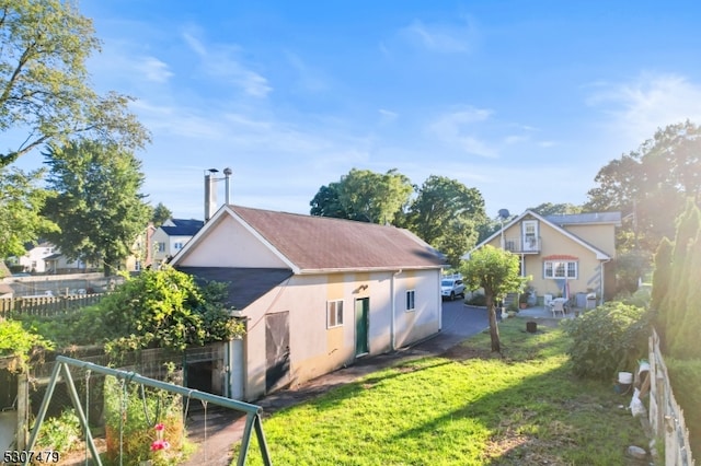 back of property with a patio and a yard