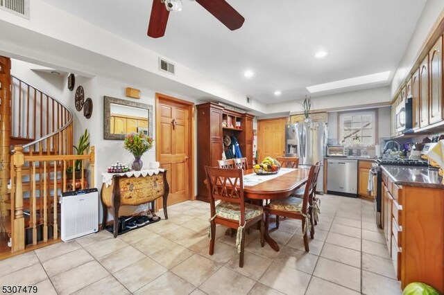 dining room featuring ceiling fan and light tile patterned floors