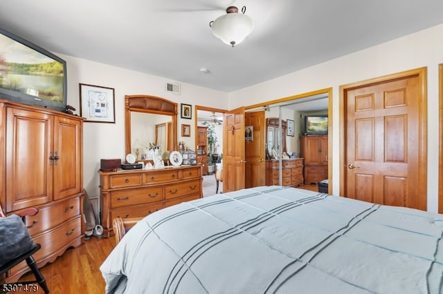 bedroom with light hardwood / wood-style flooring and a closet