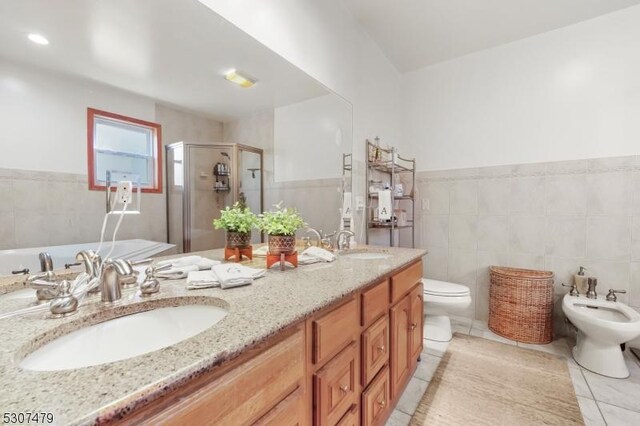 bathroom featuring toilet, tile patterned flooring, vanity, a bidet, and a shower with shower door