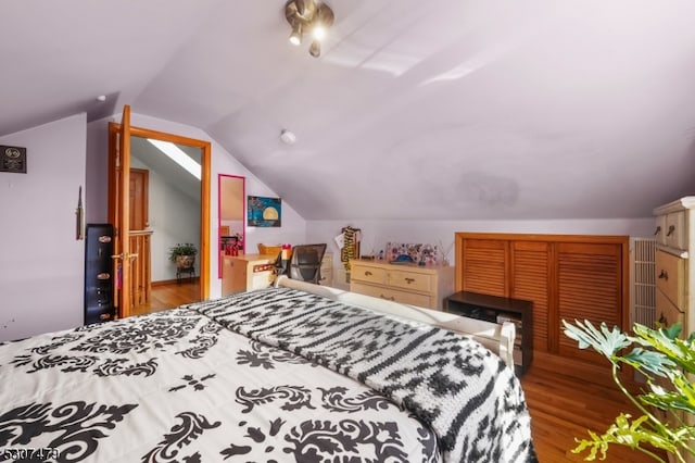 bedroom featuring lofted ceiling and wood-type flooring