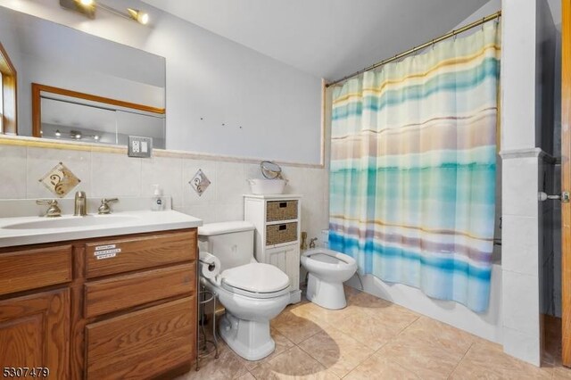 full bathroom featuring a bidet, tasteful backsplash, tile patterned floors, tile walls, and toilet