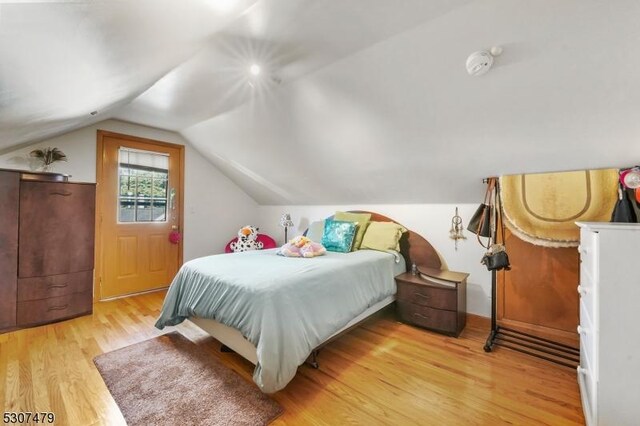 bedroom featuring vaulted ceiling and light hardwood / wood-style floors