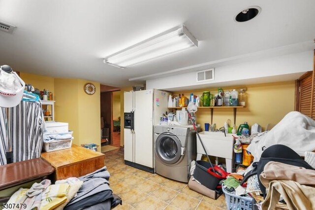 washroom with light tile patterned floors and washer / clothes dryer