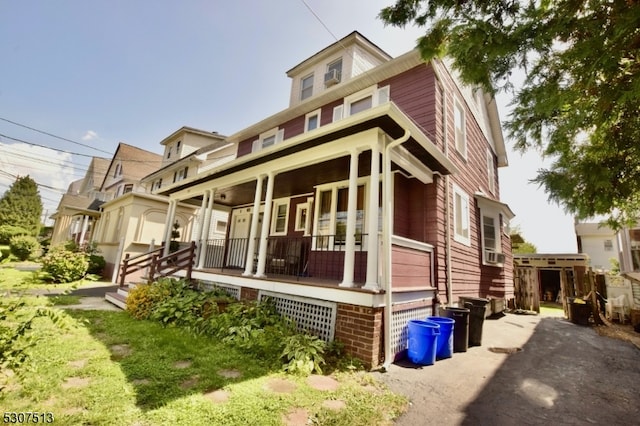 view of front facade featuring a porch and cooling unit