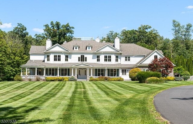 view of front of house featuring a front yard and covered porch