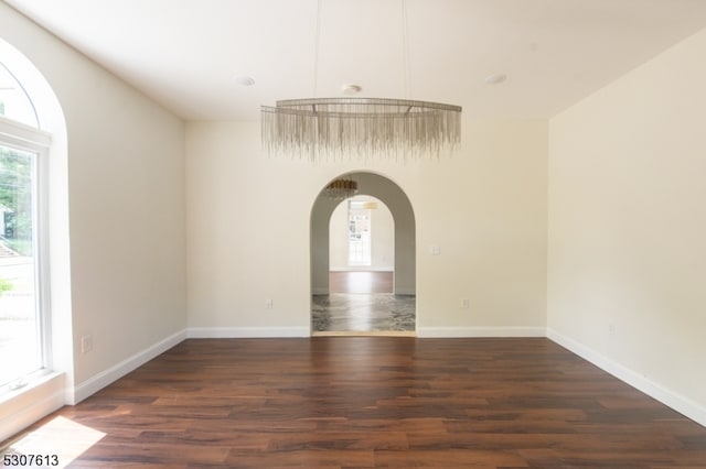 spare room with dark wood-type flooring