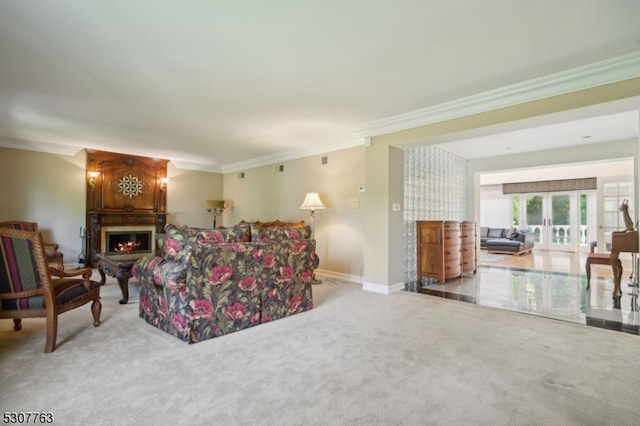 carpeted living room featuring a large fireplace, ornamental molding, and french doors