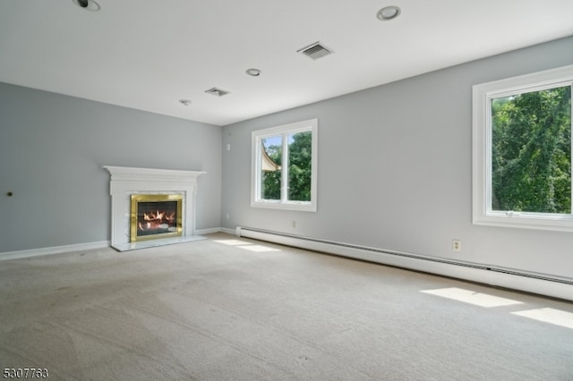 unfurnished living room with carpet floors and a baseboard heating unit