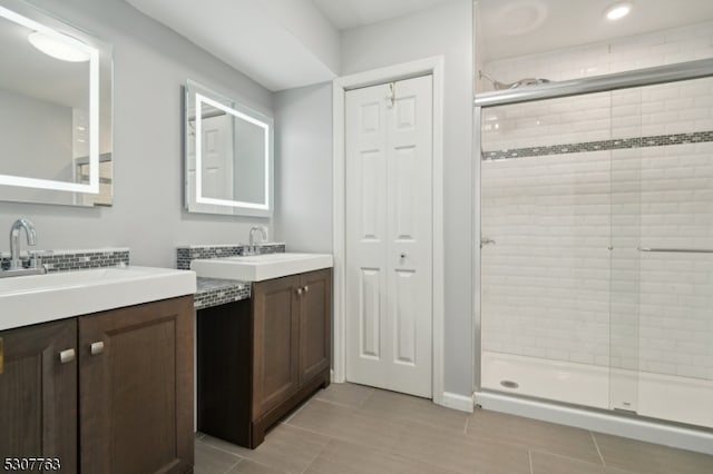 bathroom with tile patterned flooring, an enclosed shower, and vanity