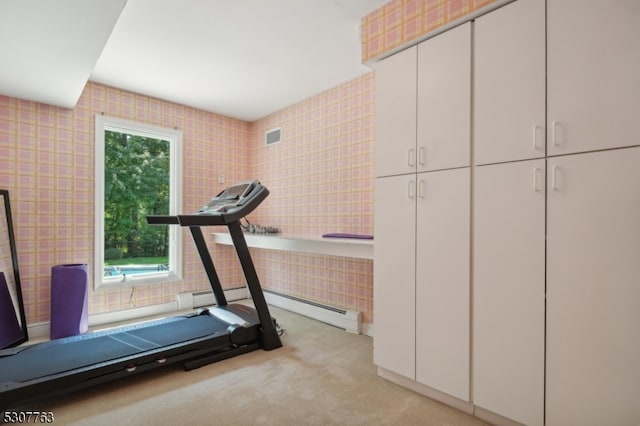 workout room with light colored carpet and baseboard heating