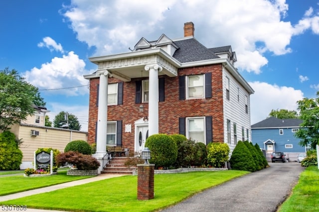 neoclassical / greek revival house with a front yard