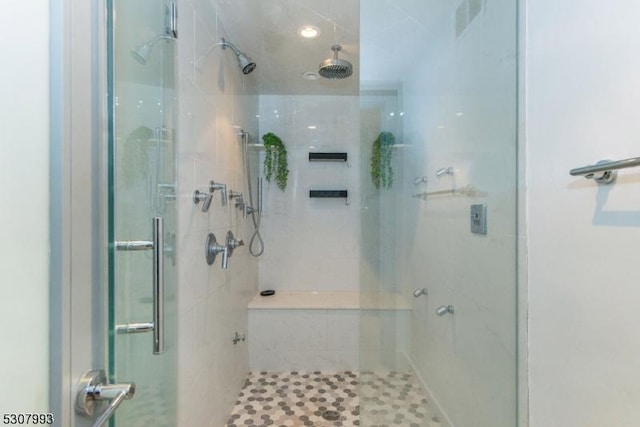 bathroom featuring visible vents and a shower stall