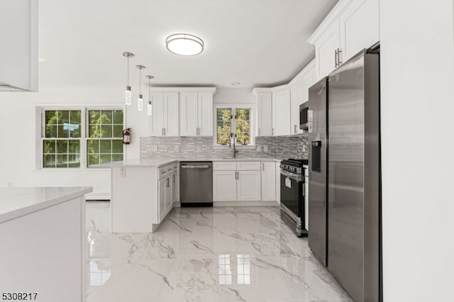 kitchen with decorative light fixtures, appliances with stainless steel finishes, sink, decorative backsplash, and white cabinetry