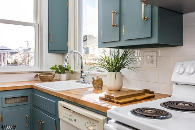 kitchen with a healthy amount of sunlight, sink, and white appliances