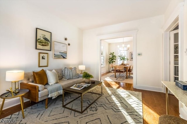 living room with hardwood / wood-style flooring and a chandelier