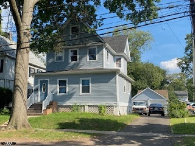 view of front of home with an outbuilding and a garage