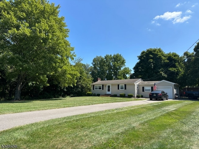 single story home with a garage and a front lawn