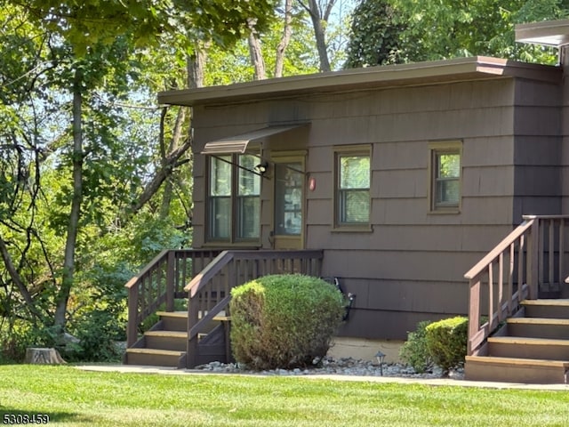 entrance to property with a lawn