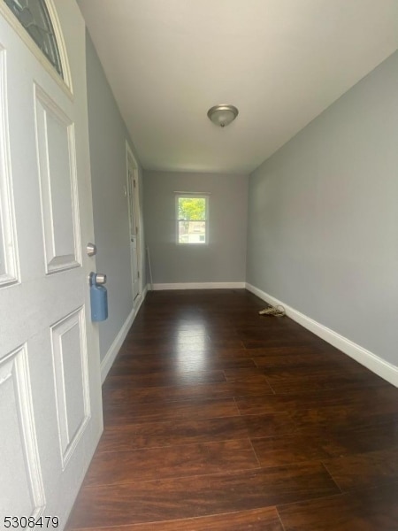 empty room with dark hardwood / wood-style floors