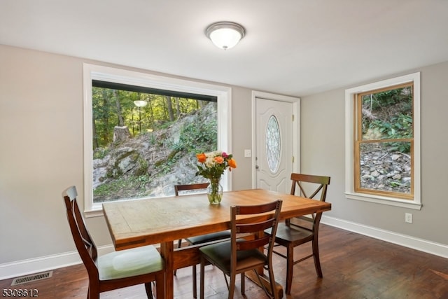 dining room with dark hardwood / wood-style flooring