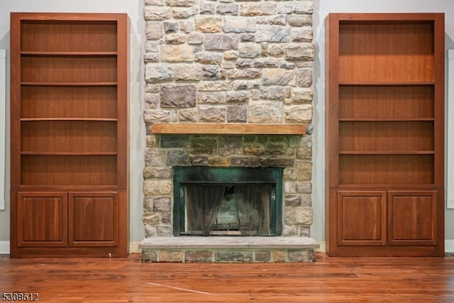 unfurnished living room featuring hardwood / wood-style flooring and a fireplace