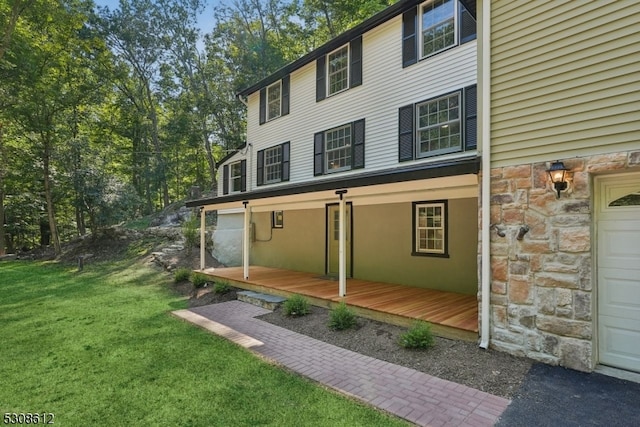 rear view of property featuring a yard