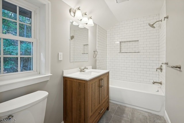 full bathroom featuring tiled shower / bath, vanity, and toilet