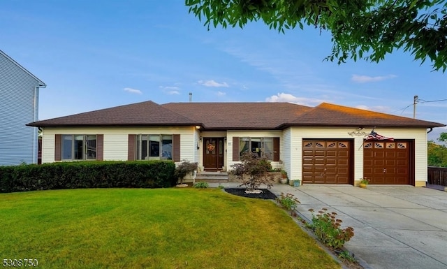 ranch-style home featuring a garage and a front lawn