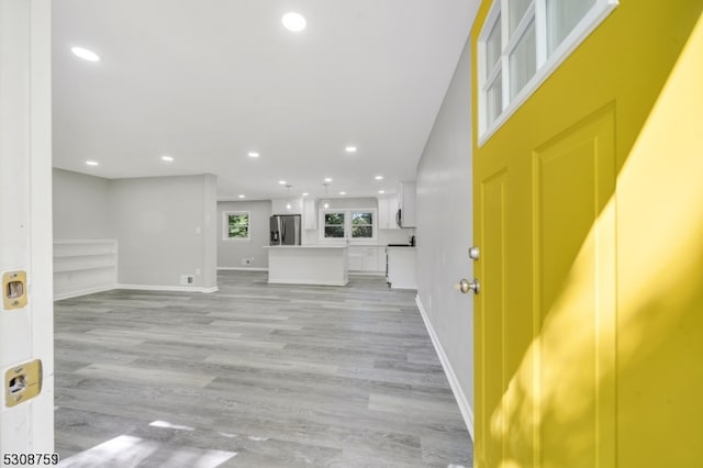 unfurnished living room featuring light wood-type flooring