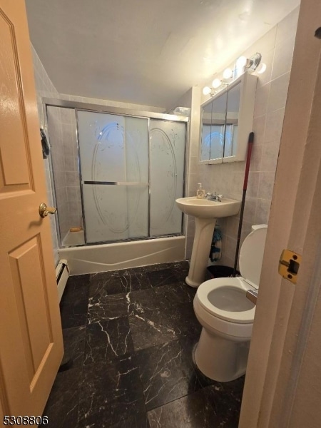 full bathroom featuring enclosed tub / shower combo, toilet, tile patterned flooring, sink, and a baseboard heating unit