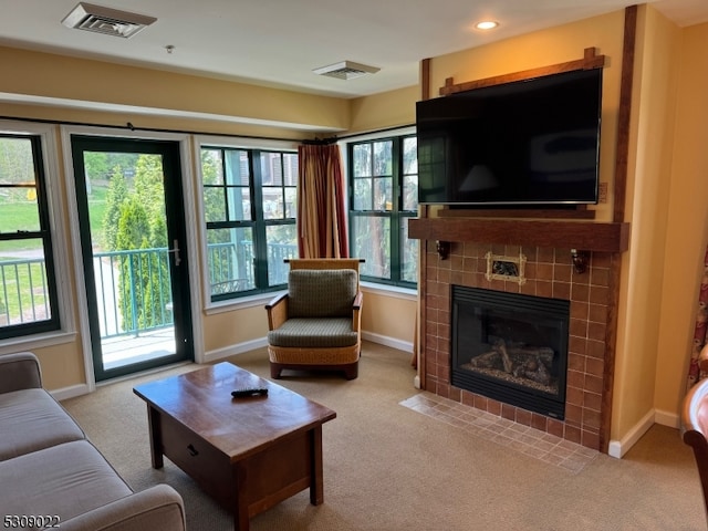 carpeted living room with a fireplace