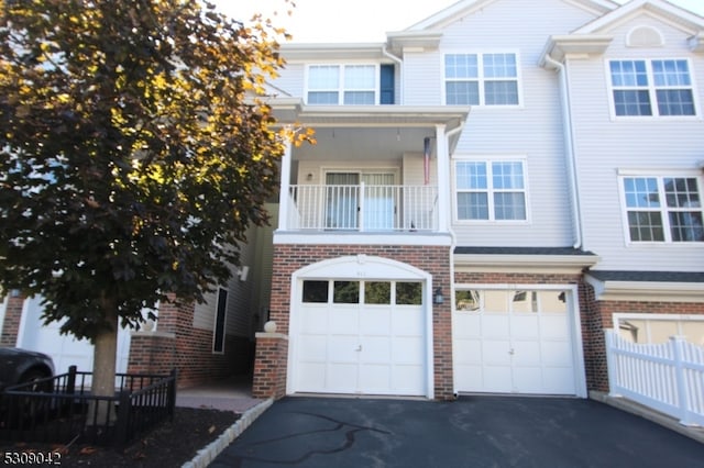 multi unit property featuring a balcony and a garage