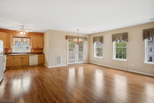 kitchen featuring decorative light fixtures, ceiling fan with notable chandelier, dishwasher, light hardwood / wood-style flooring, and sink