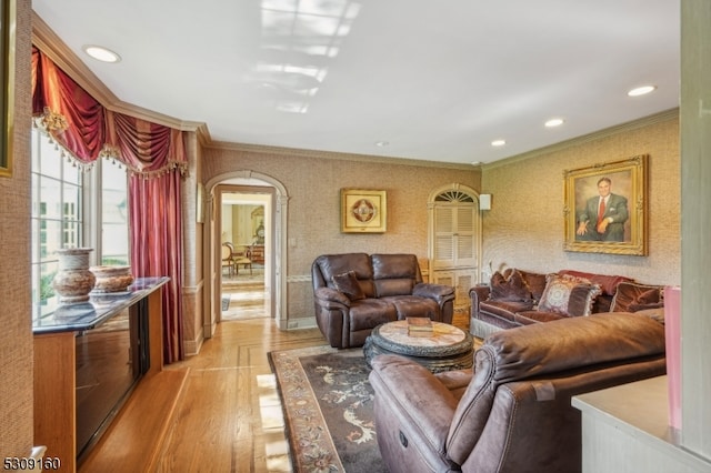 living room featuring light wood-type flooring and ornamental molding