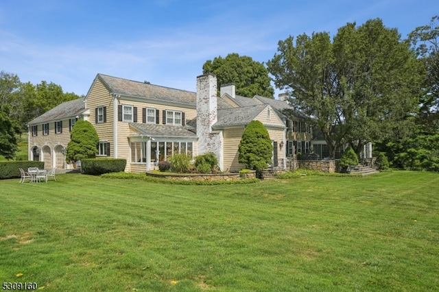 rear view of house with a yard