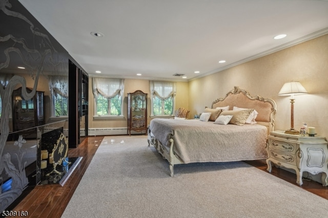 bedroom featuring baseboard heating, dark wood-type flooring, and crown molding