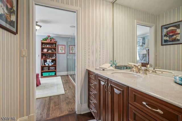 bathroom with hardwood / wood-style floors and vanity