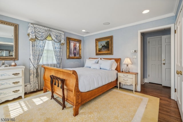 bedroom with wood-type flooring and ornamental molding